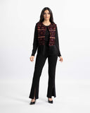 Model wearing the Bedouin Jewel open-front black-velvet vest with tatreez embroidery and fringe hem — ASHI