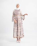 Model in a white and purple embroidered Palestinian kaftan with bell sleeves and a gold belt — ASHI