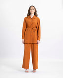 Model in the rust Whispering Breeze two-piece suit — collared button-front tunic and wide-leg trousers — ASHI