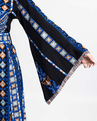 Blue Qalqilya-inspired tatreez embroidery on a black Palestinian thobe — ASHI
